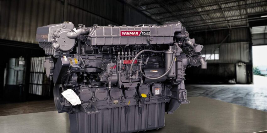 A dark colored Yanmar industrial machine in a large warehouse.