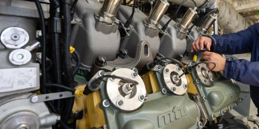 mtu diesel engine technician performing maintenance on industrial mtu engine.